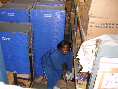 The lovely Wilma packs up for the huge warehouse move of 2009. We relocated to bigger premises and carefully wrapped nearly a quarter of a million books! / {Location}: Old warehouse 5 Thomas Road Poplar E14\\n\\n03/01/2008 15:23